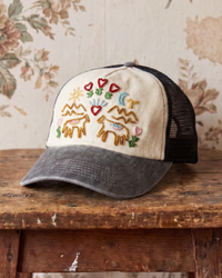 Beaded trucker hat sitting on rustic table