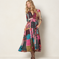 Girl wearing patchwork collared dress in cowboy boots